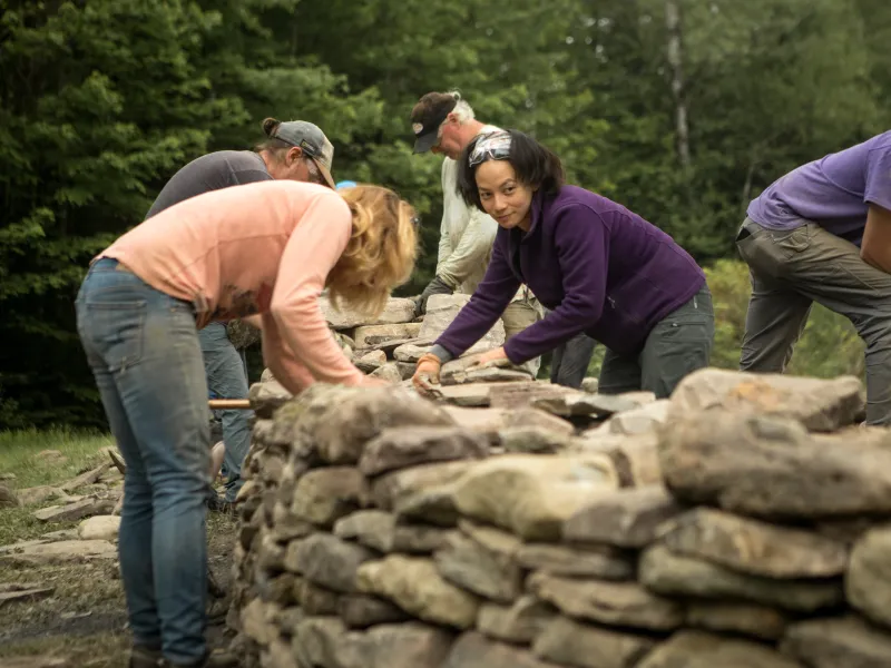 Students building a rock wall.