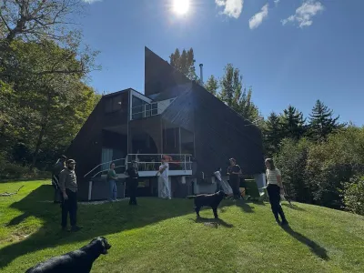 The semester cohort is photographed outside of the Sibley house on a sunny fall day.