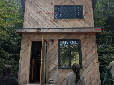 An annotated photo of the MadBush cabin showing as-built measurements and dimensions