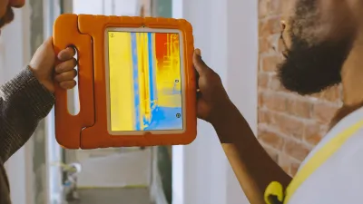 A photo of a person using a thermal imaging camera. 