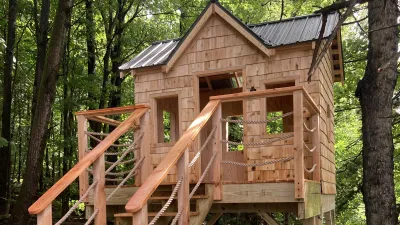 A shingled playstructure in the woods