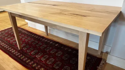 A rectangular maple dining table large enough for 4-6 people. 