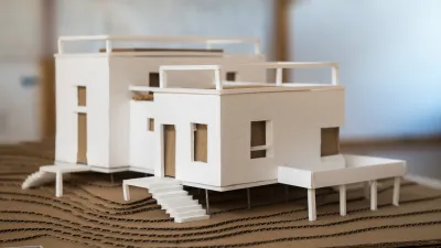 A model of the bunkhouse is photographed in the studio