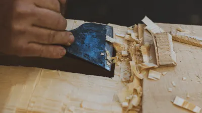 Detail shot of cutting a timber with a small axe.