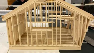 A framing model of the semester project is photographed in the main studio.