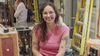 Sophie posing in the woodshop