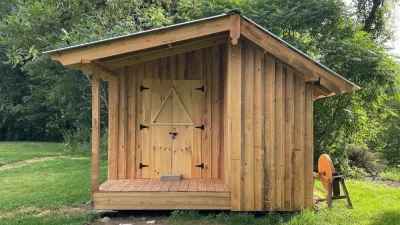 A cabin with a small covered porch. 