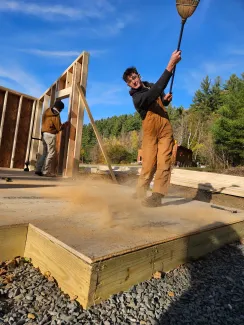 Jake sweeps dust from the floor deck