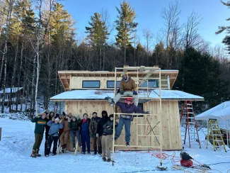 The 2025 Semester group poses in front of Casa Virga, a small house in the snow
