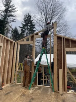 Semester students frame roof and window openings