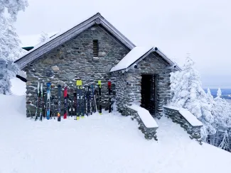 The Mansfield Stone Hut pictured post-fire renovation in the snow