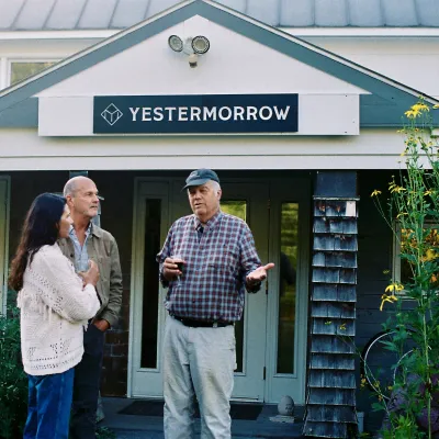 People gather under the front entrance of the main building