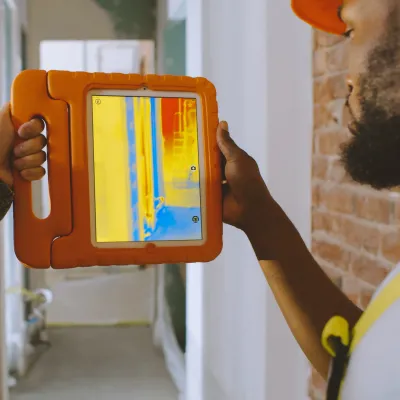 A photo of a person using a thermal imaging camera. 