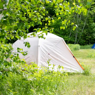 Two camping tents pictured in the lawn.