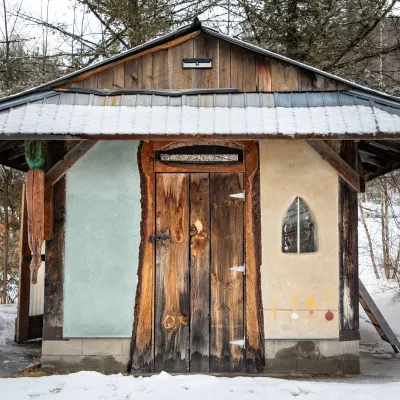 The yestermorrow carrot shed is pictured in winter with a timber frame and cob and tadelakt walls.