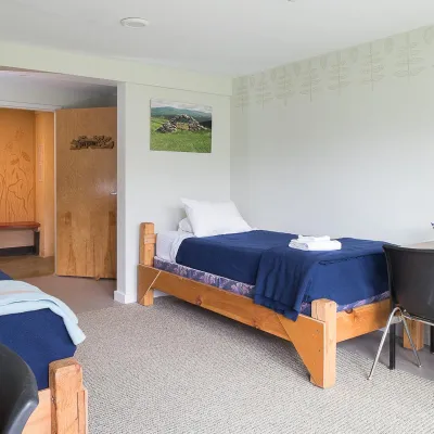 Interior shot of a dorm room with two twin beds and desk.