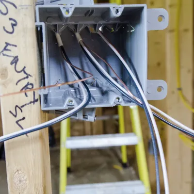 Photo of a roughed-in electrical socket with wires 