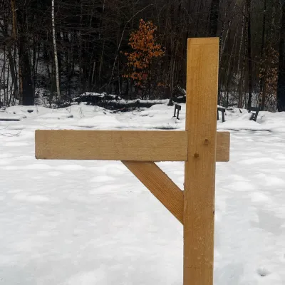 Timber framed mailbox post photographed in the snow.