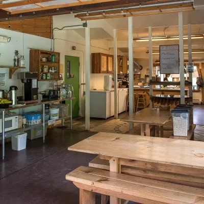 Shot of the yestermorrow kitchen, with tables in the foreground and cooking facilites in the background.