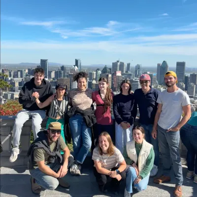 A group shot of the semester program in montreal with blue sky and buildings in the background