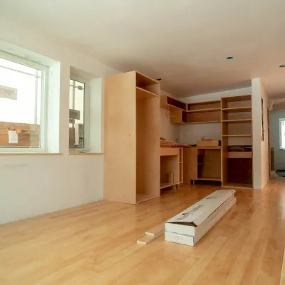 A photo of a partially completed kitchen with a finished floor and box of flooring.