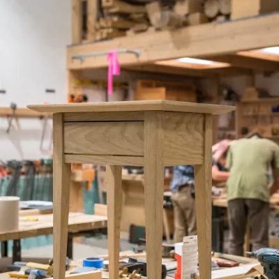 Photo of a shaker end table standing on a workbench.
