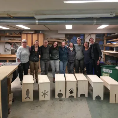 A woodshop class photo with shaker benches
