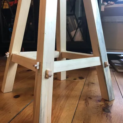 Detail shot of the bottom of a stool with through tenon joinery