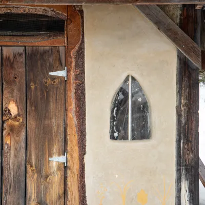 Detail shot of the wall of an outdoor garden shed with tadelakt wall and vegetable design