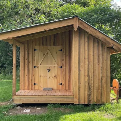 A cabin with a small covered porch. 