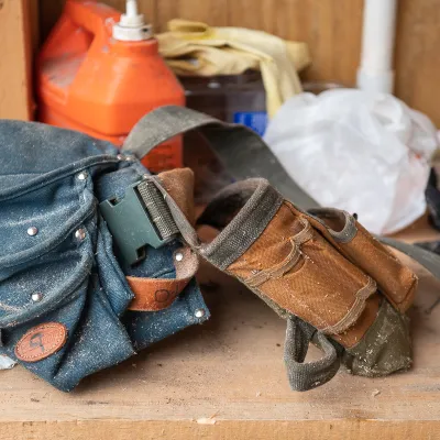 A tool belt placed on a work bench.