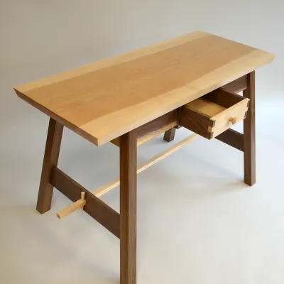 A two-toned wooden table is pictured in a photo studio