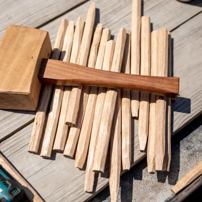Timber frame mallet and pegs outside in the sunshine
