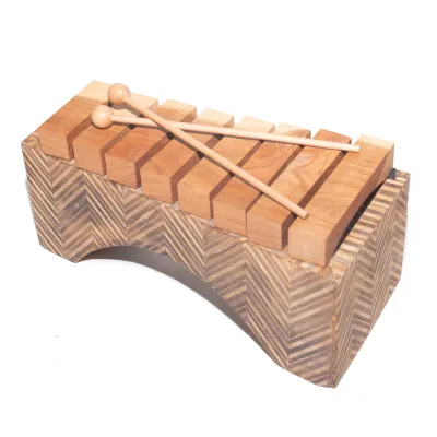 Photo studio portait of a wooden xylophone with two mallets.