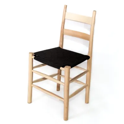 Photo studio portrait of a ladderback chair with black woven seat.